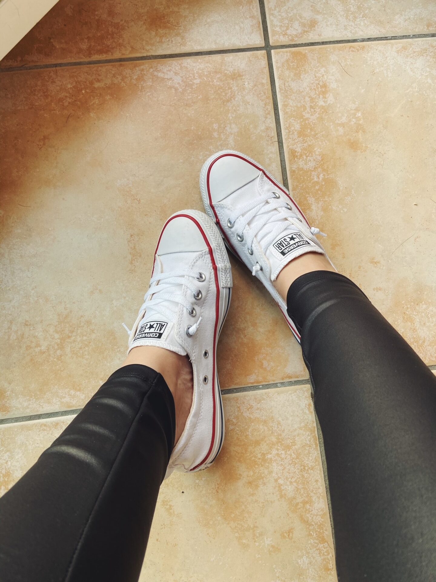 White converse with leather leggings for a casual vibe